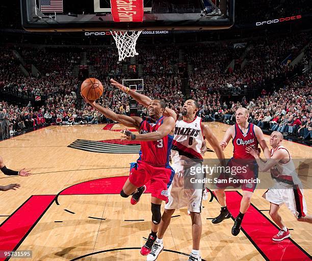 Sebastian Telfair of the Los Angeles Clippers lays up a shot against Juwan Howard of the Portland Trail Blazers during the game on December 30, 2009...