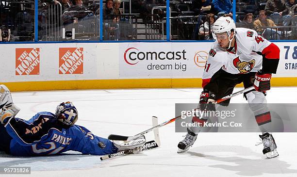 Goaltender Ondrej Pavelec of the Atlanta Thrashers saves a shot on goal by Jonathan Cheechoo of the Ottawa Senators at Philips Arena on January 12,...