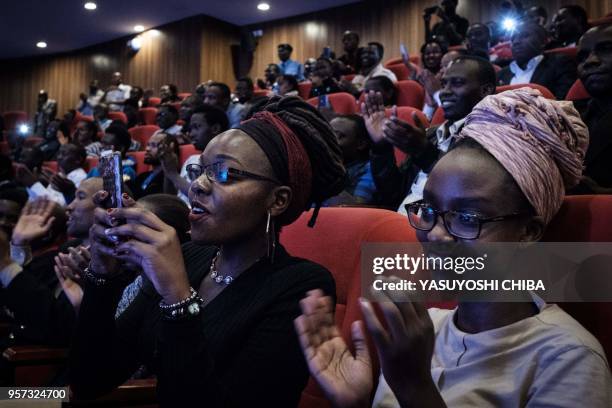 Students react during the public viewing of the deployment of Kenyas first nano satellite from the International Space Station at the University of...