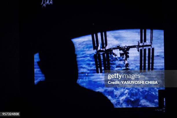 An image of the International Space Station is projected during the public viewing of deployment of Kenyas first nano satellite from the ISS at the...