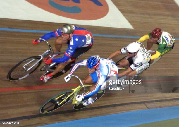 Martin Wayne Nothstein of the USA races his way to win his Keirin first heat ahead of French Laurent Gane 29 August during the World Track Cycling...