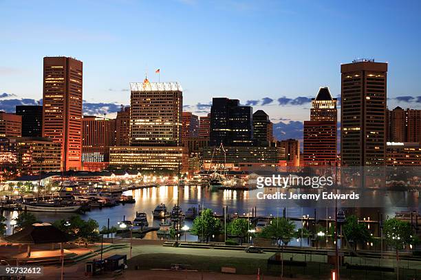 illuminated skyscrapers of inner harbor, baltimore, maryland - baltimore maryland stock pictures, royalty-free photos & images