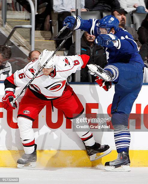 Nikolai Kulemin of the Toronto Maple Leafs is checked by Tim Gleason of the Carolina Hurricanes during game action January 12, 2010 at the Air Canada...