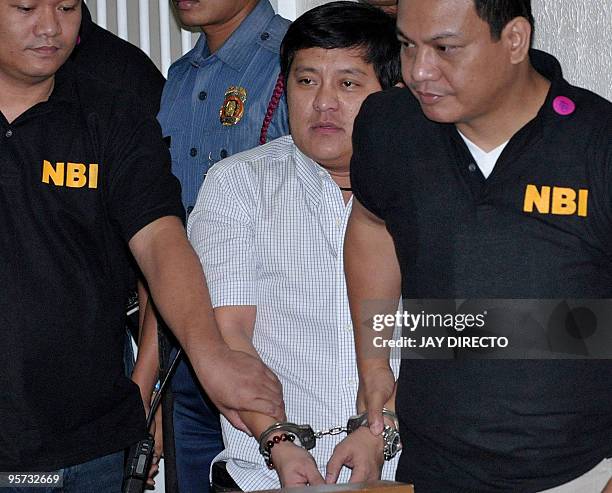 Philippine Muslim politician Andal Ampatuan Jnr is hauled to a Manila court in handcuffs by two National Bureau of Investigation agents in Manila on...