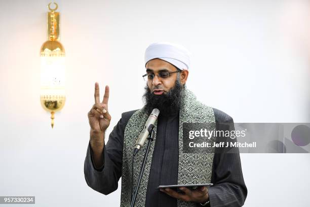 Members of the Muslim community, listen to Iman, Mufti Abdur-Rahman Mangera as they attend the opening of the first mosque built on the Western Isles...