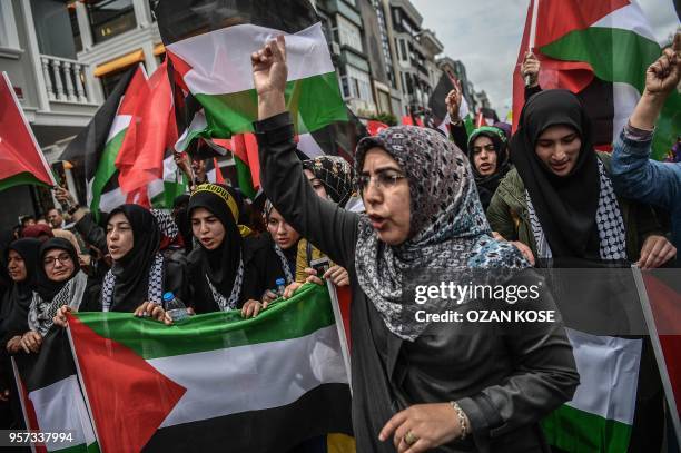 Protesters wawe Turkish and Palestinian flags as they shout slogans against Israel and USA during a demonstration in Istanbul on May 11 against US...