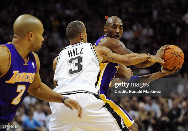Guard Kobe Bryant of the Los Angeles Lakers dribbles the ball against George Hill of the San Antonio Spurs on January 12, 2010 at AT&T Center in San...