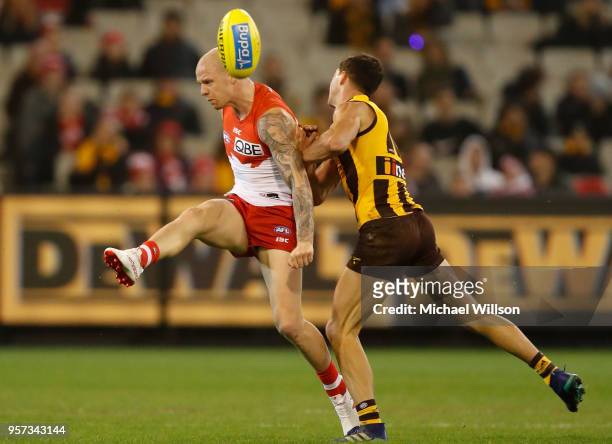 Zak Jones of the Swans is tackled by Jaeger O'Meara of the Hawks during the 2018 AFL round eight match between the Hawthorn Hawks and the Sydney...