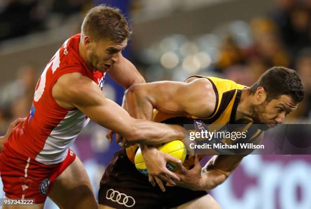 Kieren Jack of the Swans and James Frawley of the Hawks compete for the ball during the 2018 AFL round eight match between the Hawthorn Hawks and the...