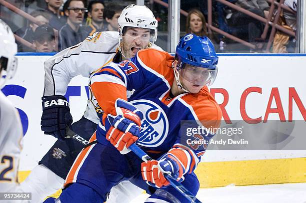 David Legwand of the Nashville Predators chases a puck carrying Denis Grebeshkov of the Edmonton Oilers at Rexall Place on January 12, 2010 in...