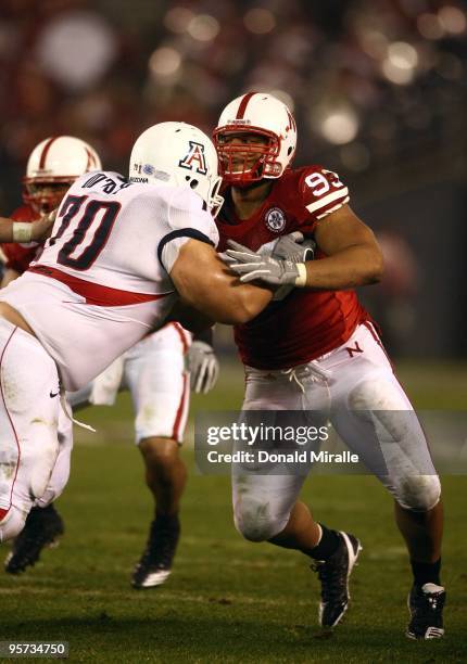 Ndamukong Suh of the University of Nebraska Cornhuskers engages an offensive lineman in a block during the Pacific Life Holiday Bowl against...