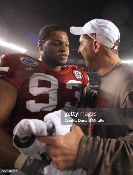 Ndamukong Suh talks with Head Coach Bo Pelini of the University of Nebraska Cornhuskers after their team's 33-0 victory against the University of...