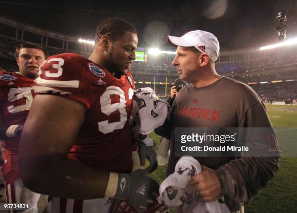 Ndamukong Suh talks with Head Coach Bo Pelini of the University of Nebraska Cornhuskers after their team's 33-0 victory against the University of...