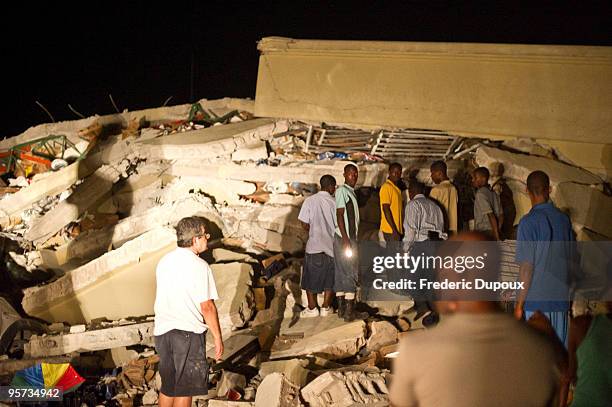 People search for survivors amongst the rubble of the Caribbean Super Market in Delmas on January 12, 2010 in Port-au-Prince, Haiti. A 7.0 earthquake...