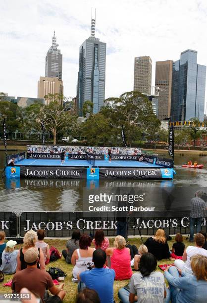 Former Australian tennis players Pat Rafter and Wally Masur play a game of tennis on a tennis court floating on the Yarra River during the inaugural...
