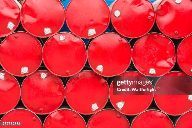 stacked blue metal barrels - red oil drum stock-fotos und bilder