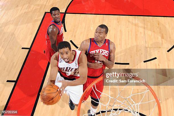 Andre Miller of the Portland Trail Blazers drives to the basket for a layup past Marreese Speights and Royal Ivey of the Philadelphia 76ers during...