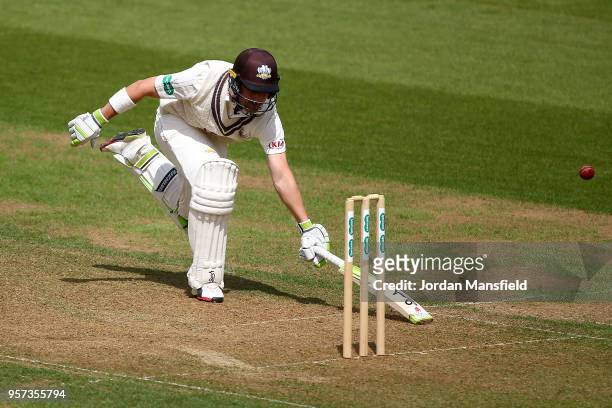 Dean Elgar of Surrey lunges to make his ground during day one of the Specsavers County Championship Division One match between Surrey and Yorkshire...