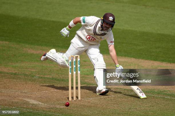 Dean Elgar of Surrey lunges to make his ground during day one of the Specsavers County Championship Division One match between Surrey and Yorkshire...