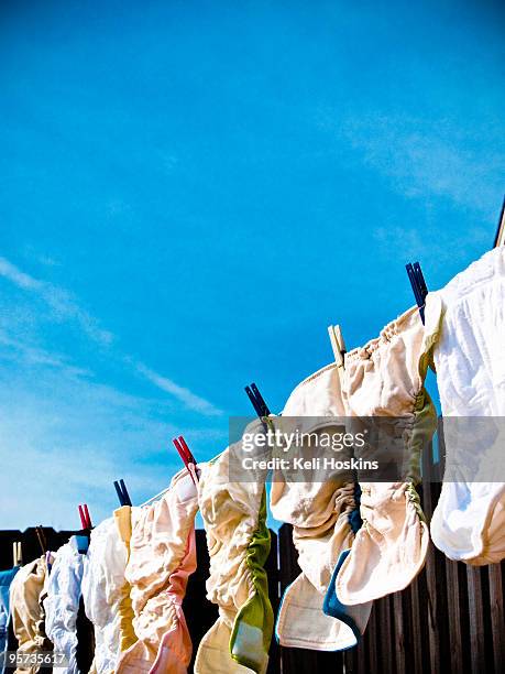 colorful cloth diapers hanging on a clothesline - reusable diaper stock pictures, royalty-free photos & images