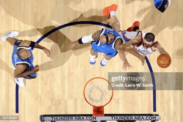 Nick Collison of the Oklahoma City Thunder shoots a layup against Drew Gooden of the Dallas Mavericks during the game at Ford Center on December 16,...