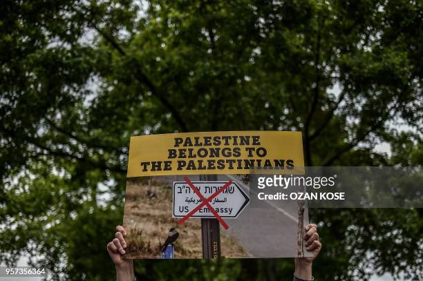 Protester holds a placard on May 11, 2018 in Istanbul during a demontration againts US President Donald Trumps controversial policy to recognize...