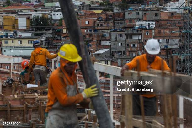 Contractors work during construction of the Reserva Paulista residential complex in Sao Paulo, Brazil, on Wednesday, March 21, 2018. The world's...