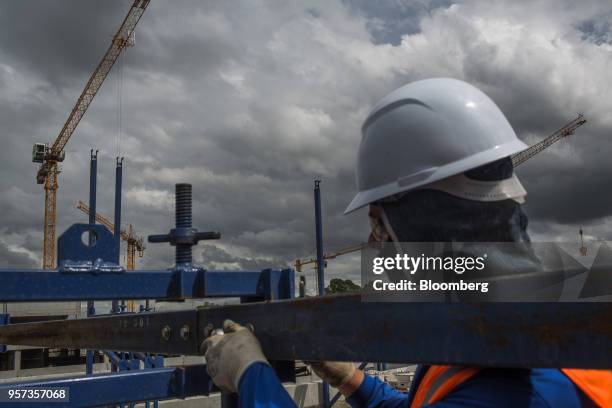 Cranes stand in front of a contractor at the Reserva Paulista residential complex under construction in Sao Paulo, Brazil, on Wednesday, March 21,...