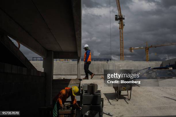 Contractors lay down cement during construction at the Reserva Paulista residential complex in Sao Paulo, Brazil, on Wednesday, March 21, 2018. The...