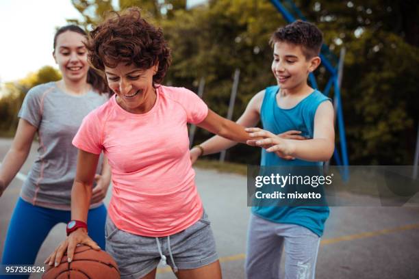 dribbling with my mom - son daughter stock pictures, royalty-free photos & images