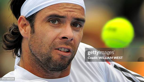 Fernando Gonzalez of Chile spins keeps his eyes on the ball during his loss to Fernando Verdasco of Spain at the Kooyong Classic tennis tournament,...