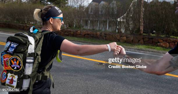 Team Mitchell's Lindsey Mahoney gets a fist bump from teammate Drew Caplin as she starts her 2-4 mile segment of the Ruck4HIT 36-hour relay run...