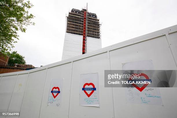Construction work is seen continuing on the burned-out shell of Grenfell Tower in west London on May 11, 2018. - British Prime Minister Theresa May...