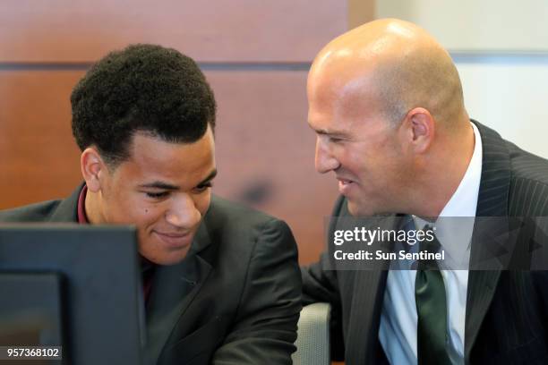 Zachary Cruz and defense attorney Mark Lowry smile as Judge Melinda Brown grants Zachary Cruz permission to relocate to Virginia to participate in...