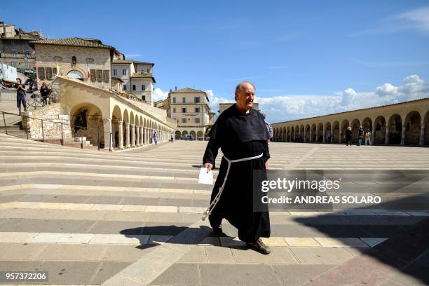 Franciscan monk walks in the Loggia of the Basilica Superiore and the Basilica Inferiore of St Francis of Assisi, in Assisi, on May 11, 2018. -...