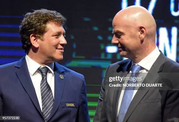 President Gianni Infantino and re-elected President of the South American Football Confederation Alejandro Dominguez, greet each other during the...