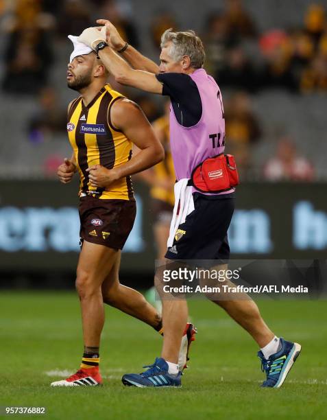 Jarman Impey of the Hawks leaves the field after a knock from Luke Parker of the Swans during the 2018 AFL round eight match between the Hawthorn...