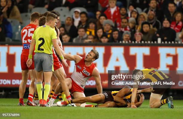 Jarman Impey of the Hawks lays on the ground after a knock from Luke Parker of the Swans during the 2018 AFL round eight match between the Hawthorn...