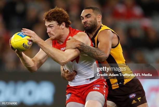 Gary Rohan of the Swans is tackled by Shaun Burgoyne of the Hawks during the 2018 AFL round eight match between the Hawthorn Hawks and the Sydney...