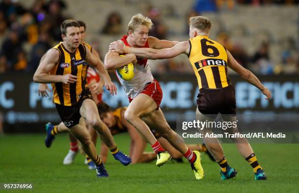 Isaac Heeney of the Swans fends off James Sicily of the Hawks during the 2018 AFL round eight match between the Hawthorn Hawks and the Sydney Swans...