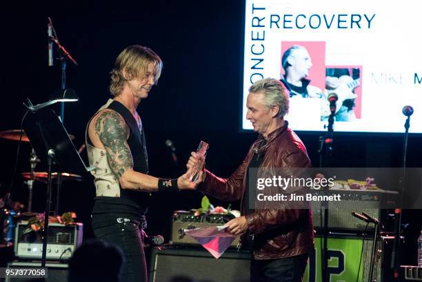 Bassist Duff McKagan presents Mike McCready with the Steve Ray Vaughan award live on stage during the MusiCares Concert for Recovery benefit at The...