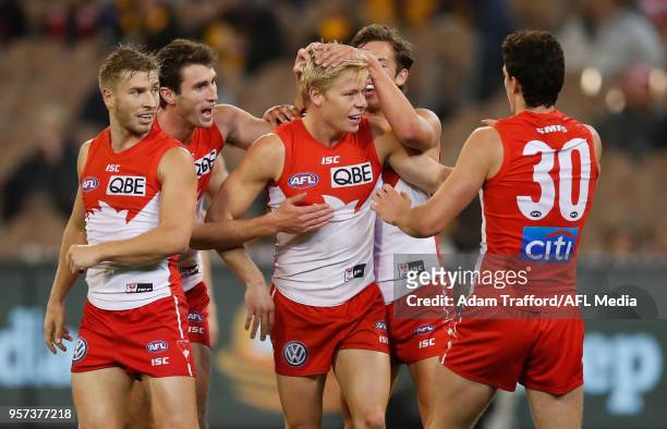 Isaac Heeney of the Swans celebrates a goal with teammates during the 2018 AFL round eight match between the Hawthorn Hawks and the Sydney Swans at...