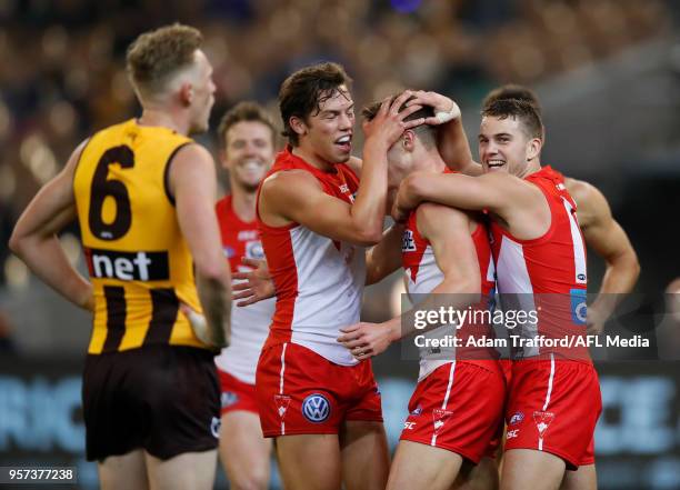 Tom Papley and Oliver Florent of the Swans congratulate youngster Ben Ronke of the Swans on his fifth goal during the 2018 AFL round eight match...