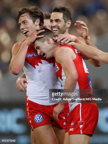 Ben Ronke of the Swans celebrates his fifth goal with Oliver Florent and Josh Kennedy of the Swans during the 2018 AFL round eight match between the...