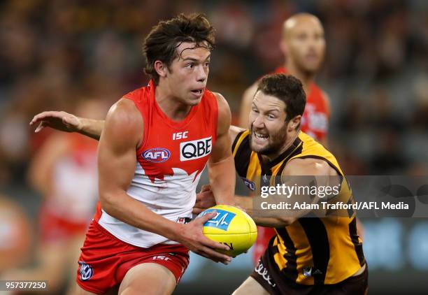 Oliver Florent of the Swans in action ahead of James Frawley of the Hawks during the 2018 AFL round eight match between the Hawthorn Hawks and the...