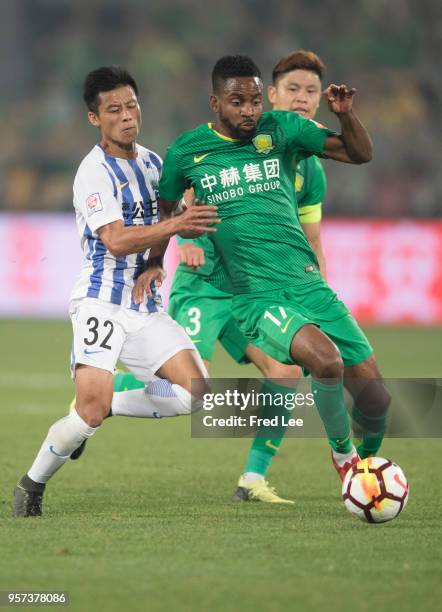 Cedric Bakambu of Beijing Guoan adn Chen Zhizhao of Guangzhou R&F in action during 2018 China Super League match between Beijing Guoan and Guangzhou...