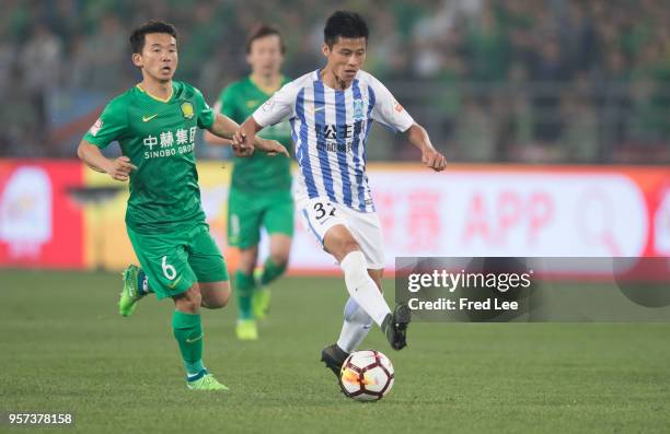 Chi Zhongguo of Beijing Guoan adn Chen Zhizhao of Guangzhou R&F in action during 2018 China Super League match between Beijing Guoan and Guangzhou...