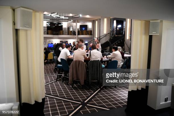 People play poker at the first Tranchant group's "gaming club" in Paris, on May 9, 2018. - Casinos were banned in the French capital in 1920, but a...