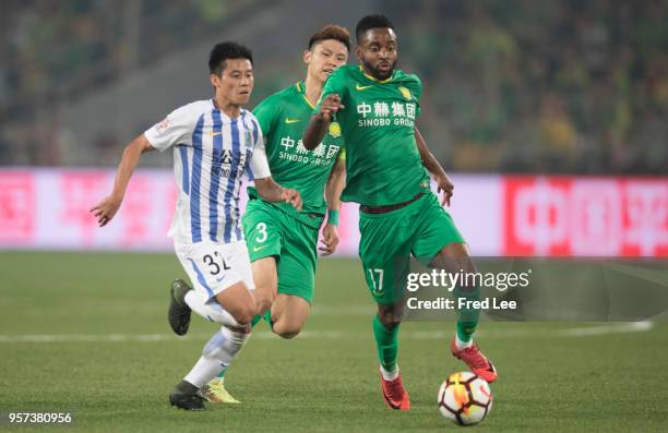 Cedric Bakambu of Beijing Guoan adn Chen Zhizhao of Guangzhou R&F in action during 2018 China Super League match between Beijing Guoan and Guangzhou...