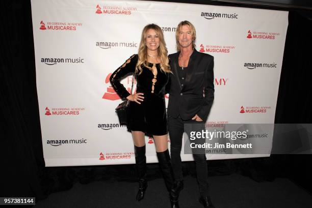 Model Susan Holmes McKagan and bassist Duff McKagan walk the carpet during the MusiCares Concert for Recovery benefit at The Showbox on May 10, 2018...